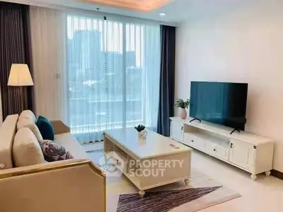 Elegant living room with modern decor and large TV, perfect for relaxation.