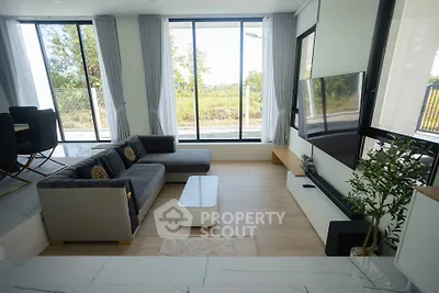 Spacious modern living room with large windows and stylish furniture