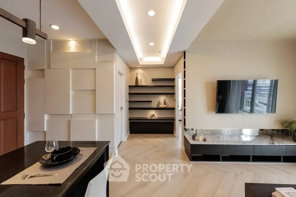 Modern living room with sleek design and open layout, featuring elegant lighting and stylish decor.
