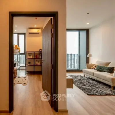 Modern apartment interior with cozy living room and bedroom, featuring wooden flooring and natural light.