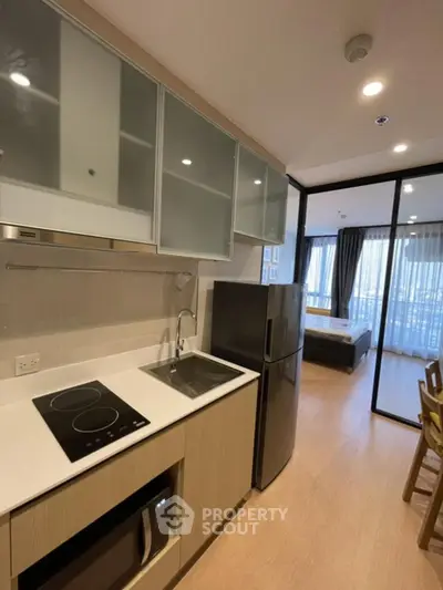 Modern kitchen with sleek appliances and open layout in stylish apartment