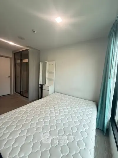 Modern bedroom with large window and minimalist furniture, perfect for natural light lovers.