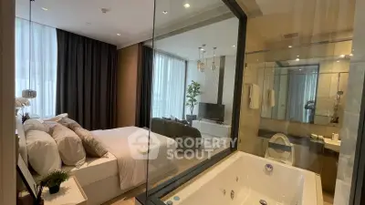 Luxurious bedroom with ensuite bathroom featuring a modern bathtub and elegant decor.