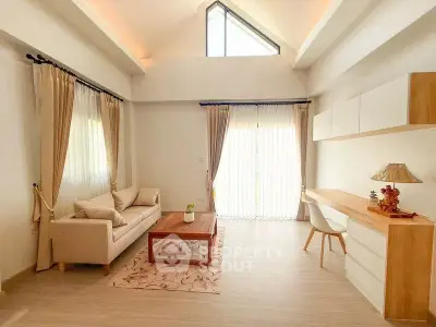 Spacious living room with high ceiling and modern decor