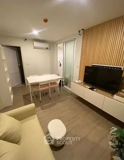 Modern living room with sleek furniture and wooden accents, perfect for cozy gatherings.