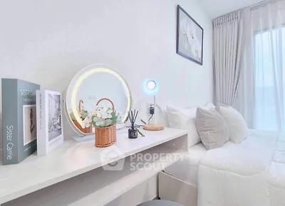 Chic bedroom with modern decor and cozy ambiance, featuring a stylish vanity and elegant bedding.