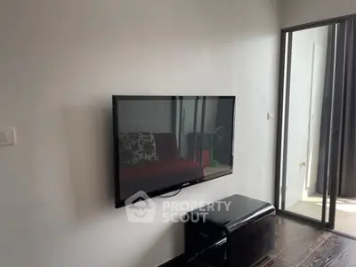 Modern living room with wall-mounted TV and sleek furniture