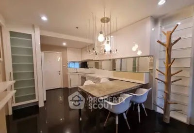 Modern kitchen with sleek design, featuring elegant lighting and a stylish dining area.