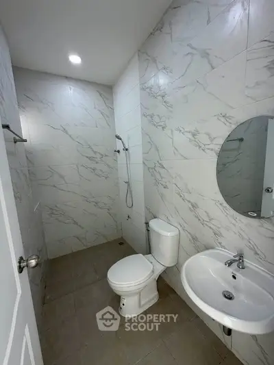 Modern bathroom with marble tiles and sleek fixtures