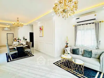 Luxurious living and dining area with elegant chandeliers and modern decor.