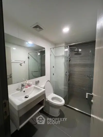 Modern bathroom with glass shower and sleek fixtures