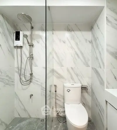 Modern bathroom with marble tiles and sleek shower design