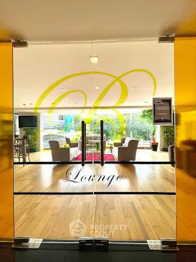 Elegant lounge entrance with glass doors and stylish interior design
