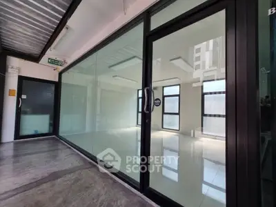 Spacious modern office space with glass walls and polished concrete floors