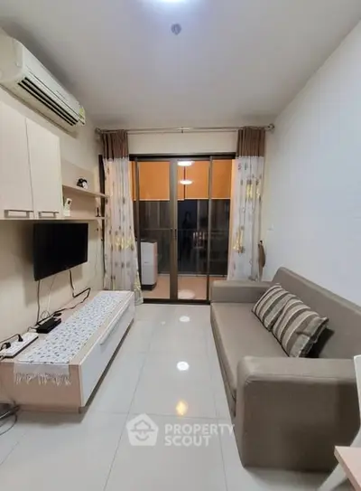 Modern living room with sleek furniture and balcony access