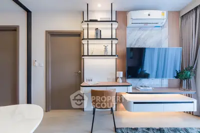 Modern living room with stylish furniture and wall-mounted TV in a contemporary apartment.