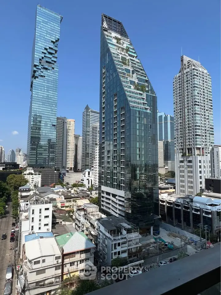 Stunning cityscape view showcasing modern skyscrapers and urban architecture under a clear blue sky.
