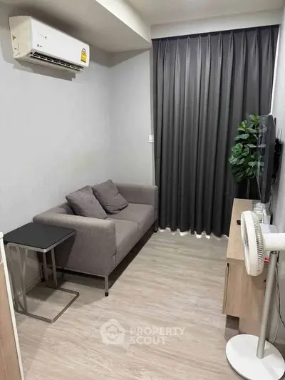 Cozy living room with modern sofa, air conditioning, and stylish decor