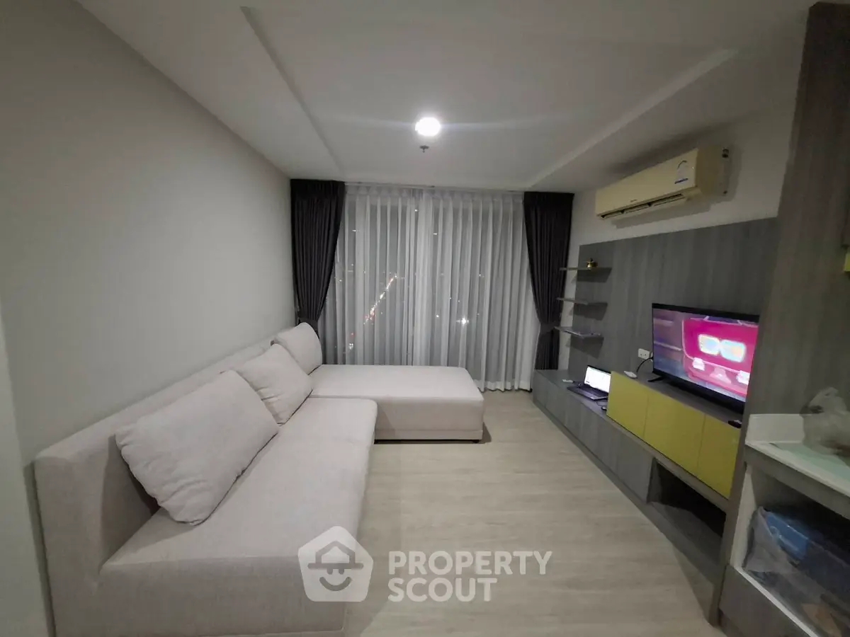 Modern living room with cozy sectional sofa and entertainment center