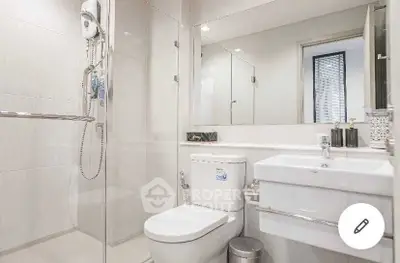 Modern bathroom with glass shower and sleek fixtures in a contemporary home.