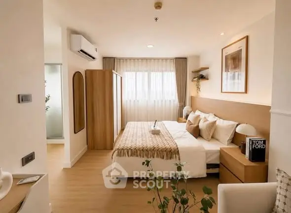 Elegant bedroom with modern decor and natural light, featuring a cozy bed and stylish furnishings.