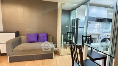 Modern living room with glass dining table and sleek kitchen appliances