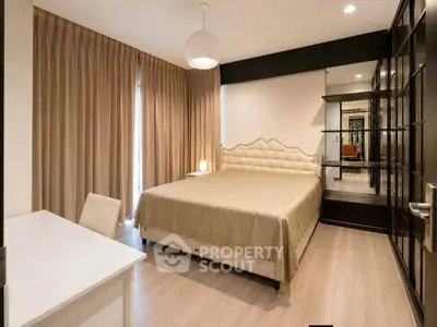 Luxurious bedroom with elegant decor and ample natural light, featuring a plush bed and stylish furnishings.