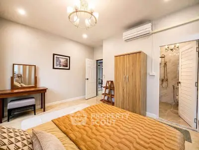 Spacious bedroom with elegant decor and ensuite bathroom in modern apartment