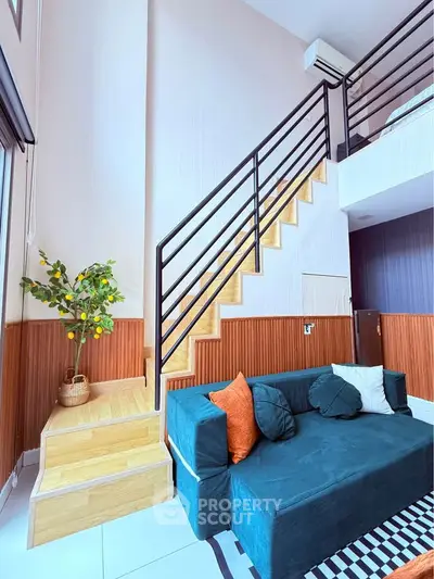 Modern duplex living room with stylish staircase and cozy seating area