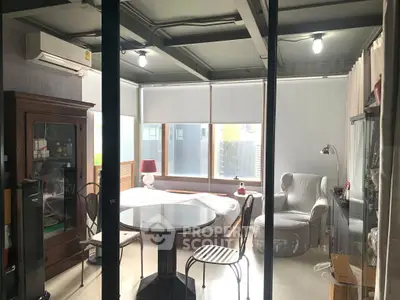 Modern studio apartment with stylish furniture and large windows for natural light.