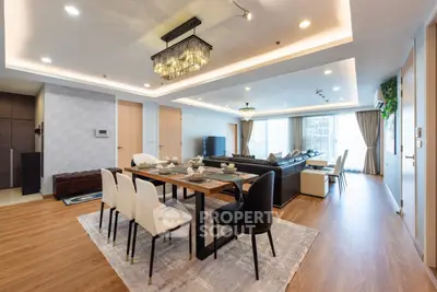 Luxurious open-plan living and dining area with elegant decor and modern lighting.