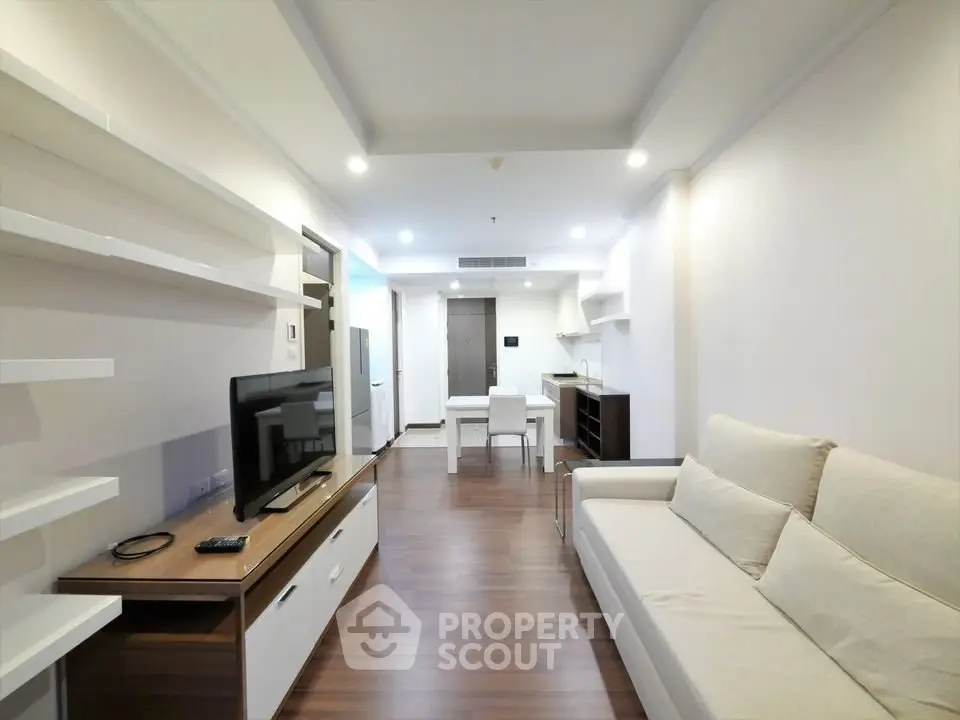 Spacious modern living room with sleek furniture and open layout, perfect for contemporary living.