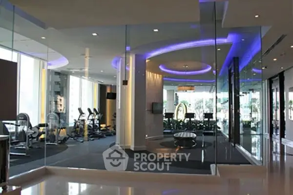 Luxurious modern gym with sleek design and ambient lighting in upscale residential building.