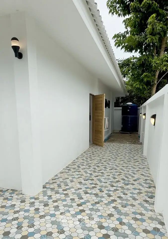 Charming exterior walkway with geometric tile design and modern lighting