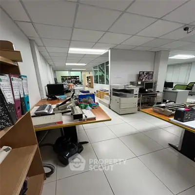 Spacious office interior with modern equipment and organized workspace, ideal for productivity and collaboration.