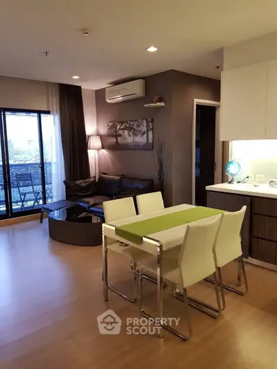 Modern open-plan living room with dining area and balcony view