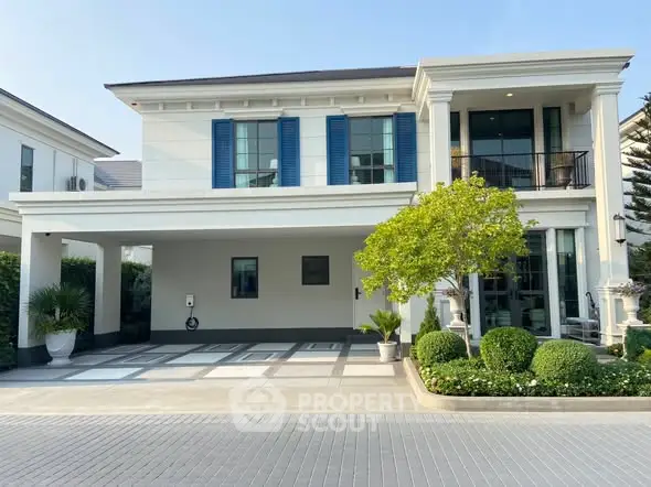Elegant modern house with spacious driveway and lush greenery in a serene neighborhood.