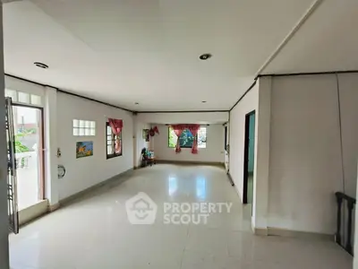 Spacious empty living room with large windows and natural light