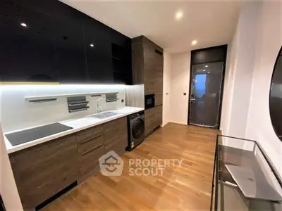 Modern kitchen with sleek cabinetry and built-in appliances in a stylish apartment.