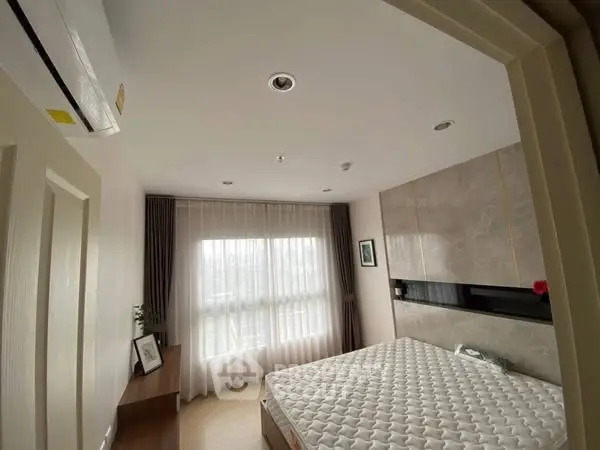Modern bedroom with large window and stylish decor