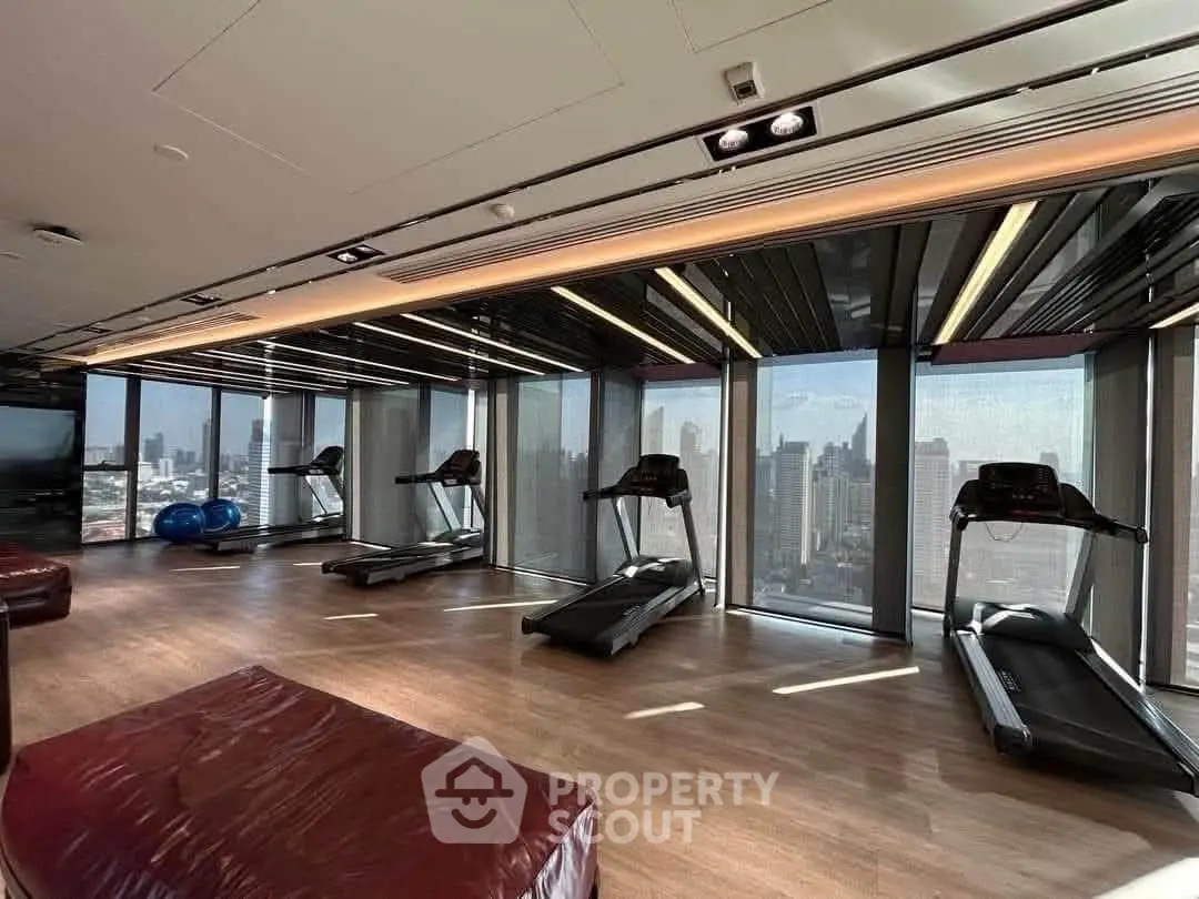 Luxurious high-rise gym with panoramic city views and modern fitness equipment.