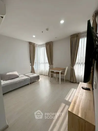 Bright and airy living room with modern minimalist decor and large windows.