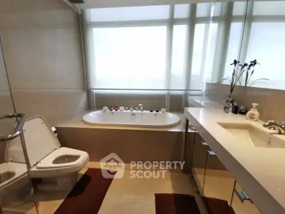 Luxurious bathroom with modern fixtures and large bathtub, perfect for relaxation.