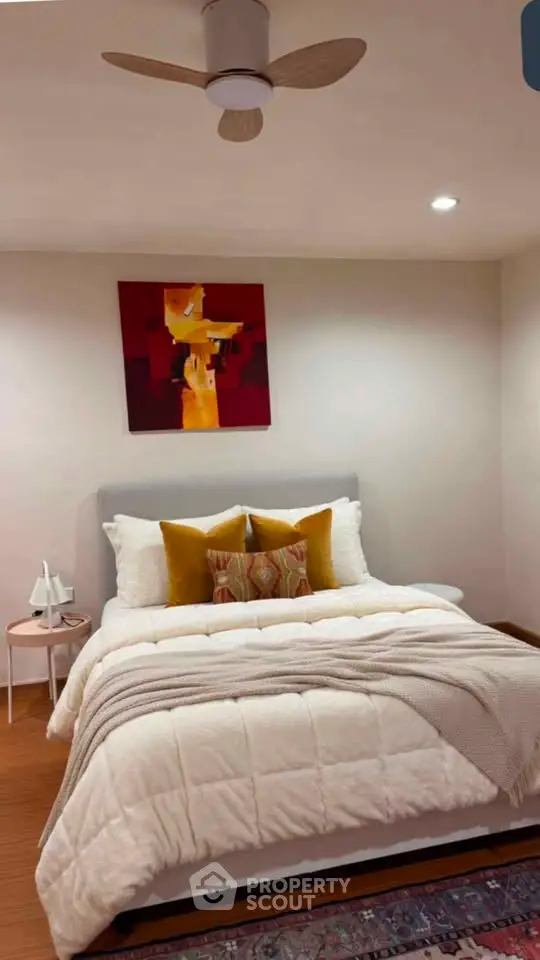 Cozy bedroom with modern decor and stylish bedding in a well-lit space.