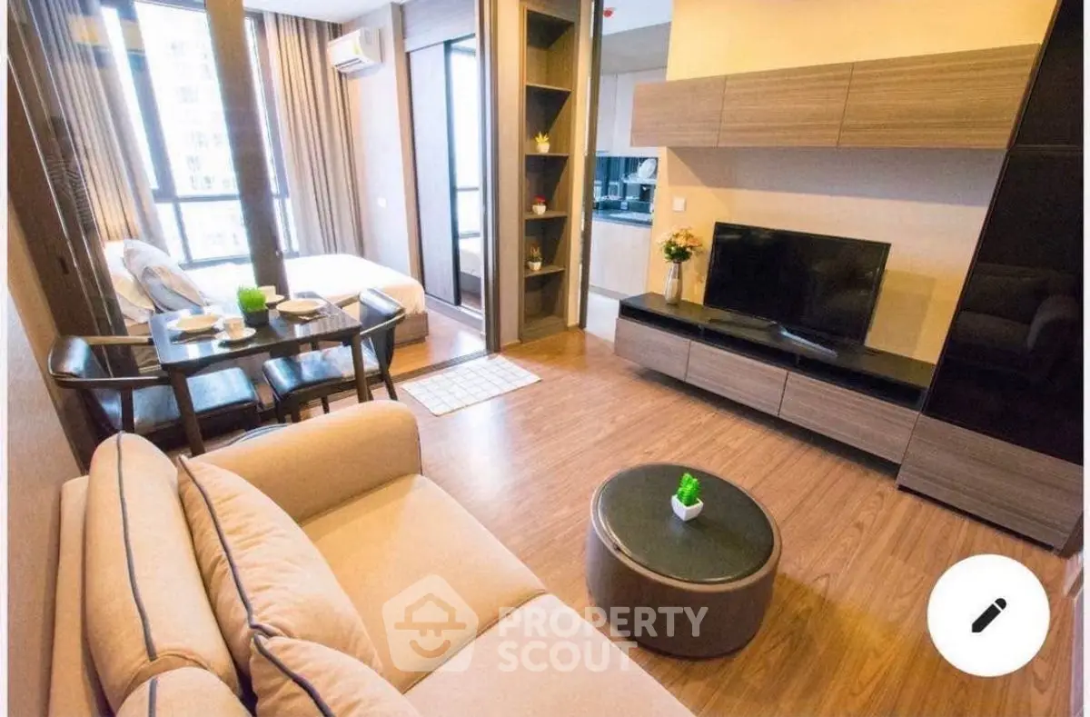 Modern living room with cozy seating and stylish decor in open layout apartment.