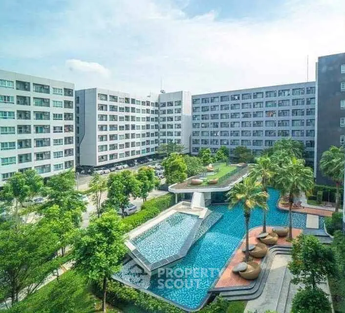 Luxurious apartment complex with stunning pool and lush greenery, perfect for modern living.