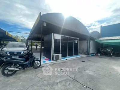 Modern commercial property with parking space and unique architectural design.