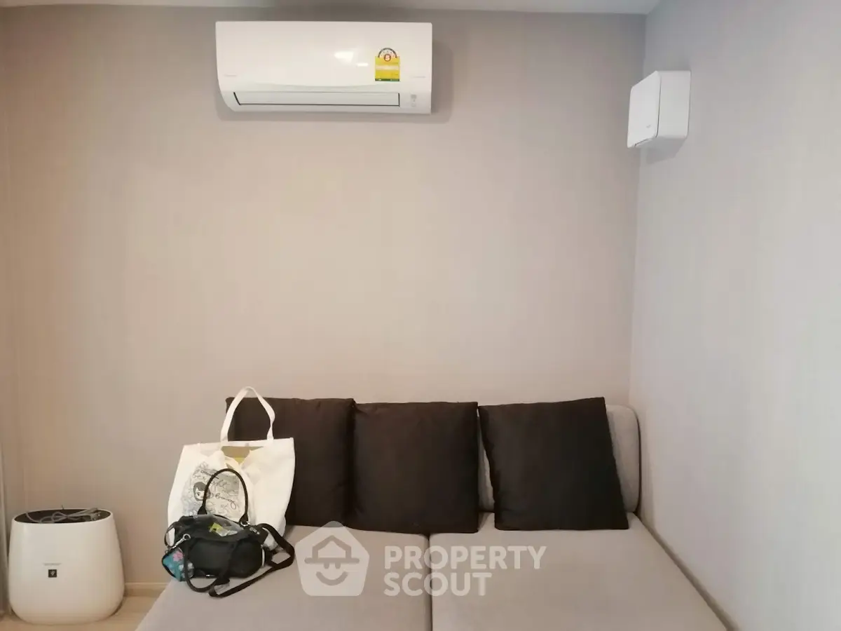 Modern living room with air conditioning and stylish sofa, perfect for relaxation and comfort.