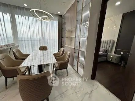 Luxurious dining area with modern chandelier and elegant decor