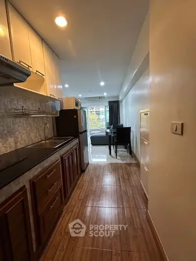 Modern kitchen with open layout leading to cozy living area and dining space.